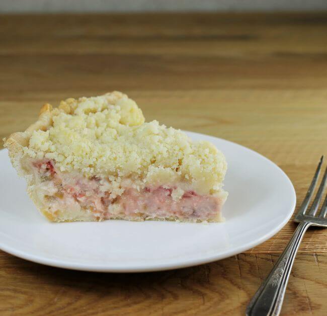 A side view of a rhubarb strawberry pie.