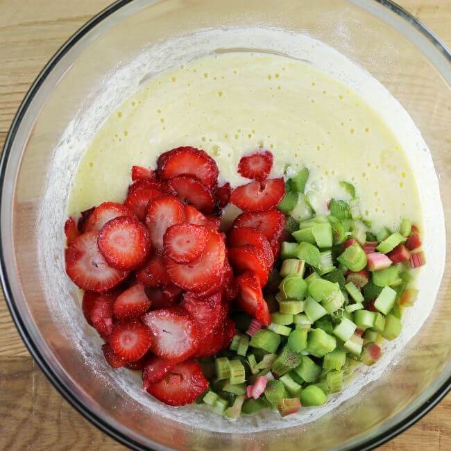 Strawberries and rhubarb are added to the sour cream mixture.