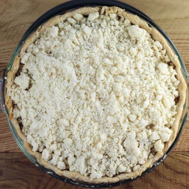 The crumb topping is sprinkled over top of the pie.