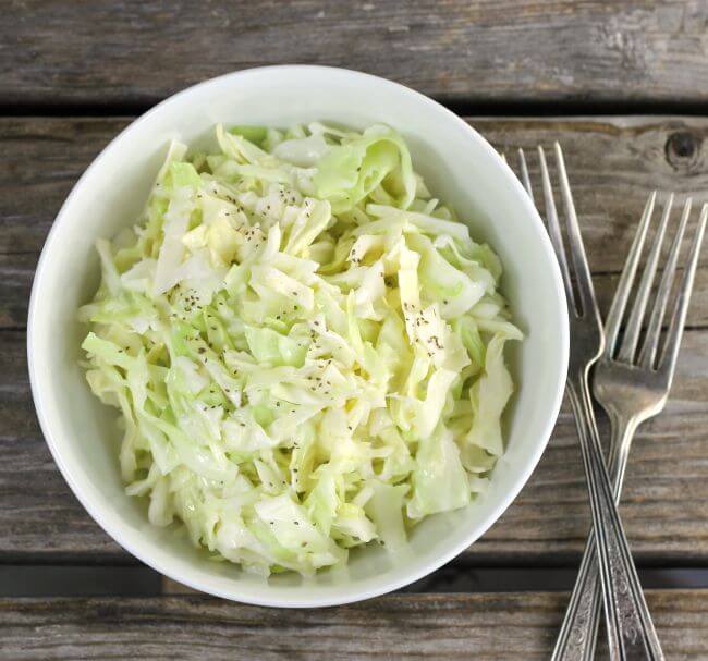 Overhead view of coleslaw in a white bowl.