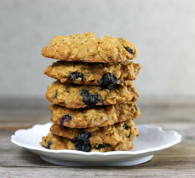 A stack of blueberry oat cookies on a white plate.