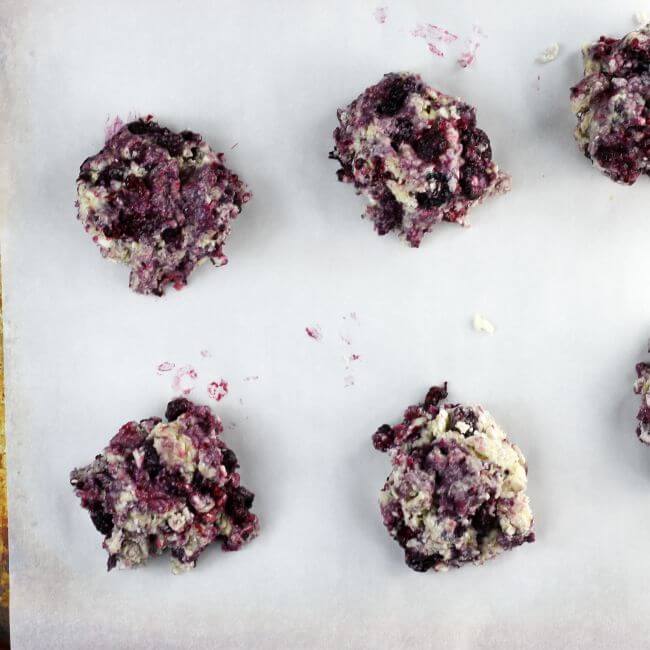 Unbaked scones on lined baking sheet.