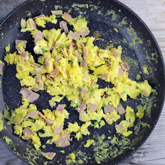 Scrambled eggs in a large skillet.