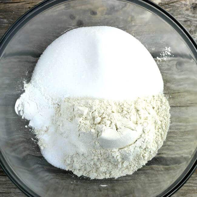 Flour and sugar in a glass bowl.