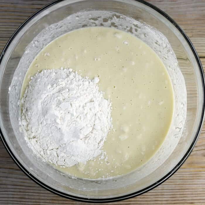 A cup of flour is added to the dough.