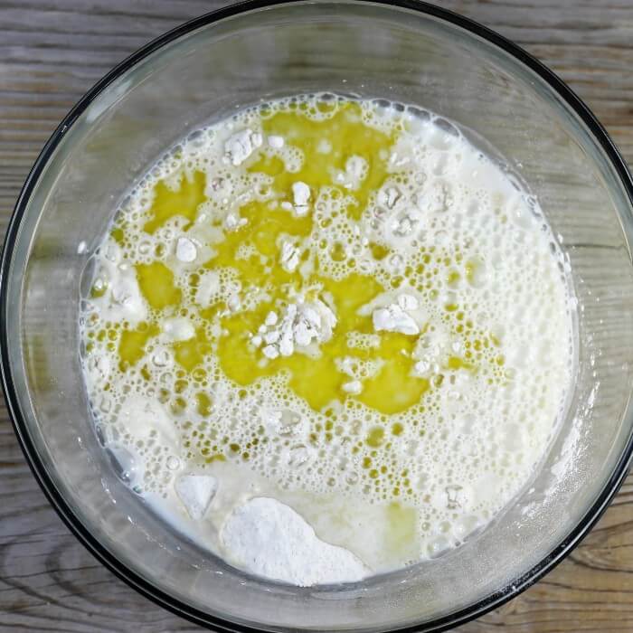 The milk/water and the olive oil are added to the flour mixture. 