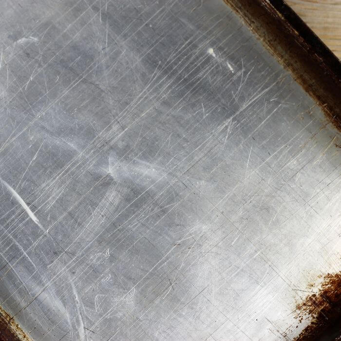 Looking down at a baking sheet that has been greased with shortening.