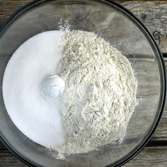 Flour, sugar, and baking powder in a glass bowl