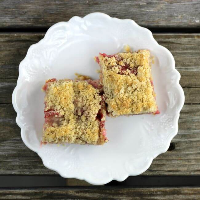 Overhead view of the strawberry bars on a white plate.