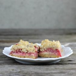 Side view of two strawberry bars on a white plate