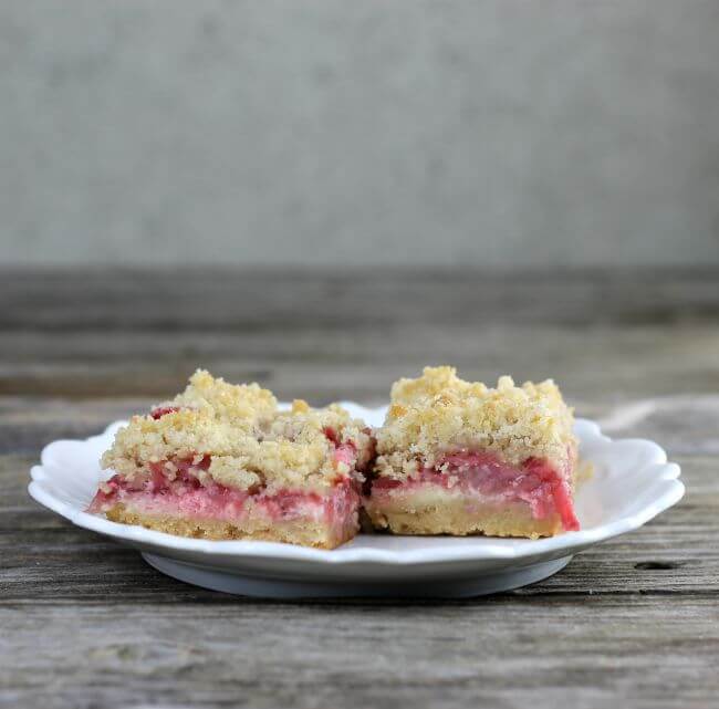 Side view of two strawberry bars on a white plate