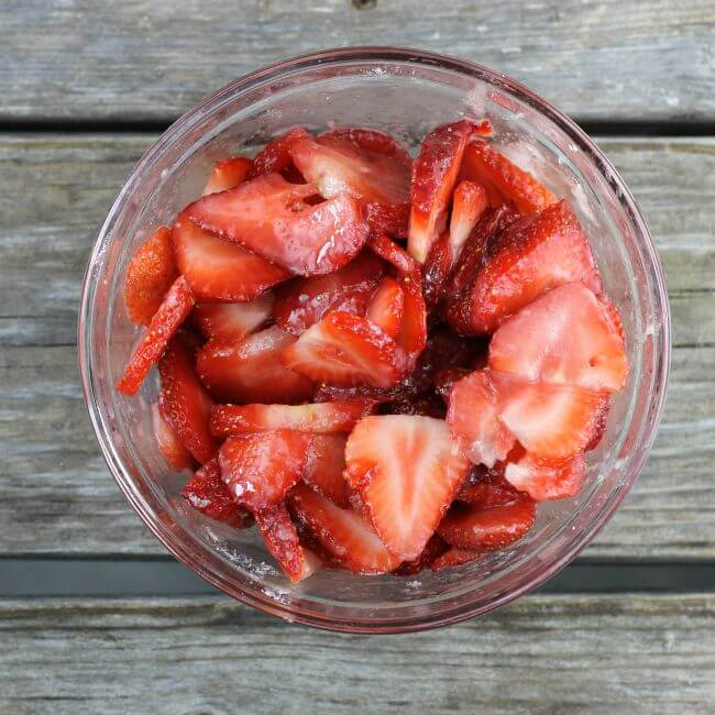 Sliced strawberries in a blowl.