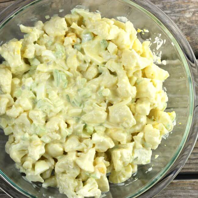 Cauliflower potato salad in a glass bowl.