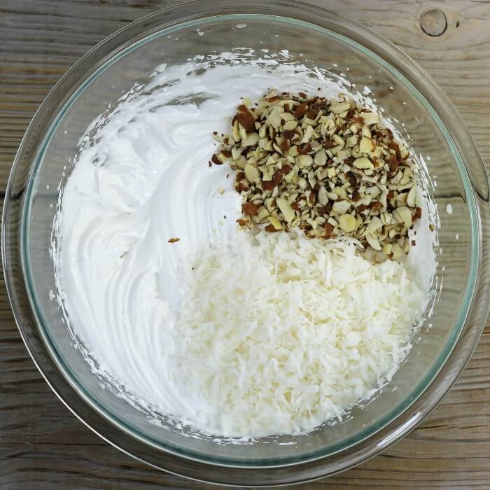 Chopped almonds and coconut are added to the egg whites. 
