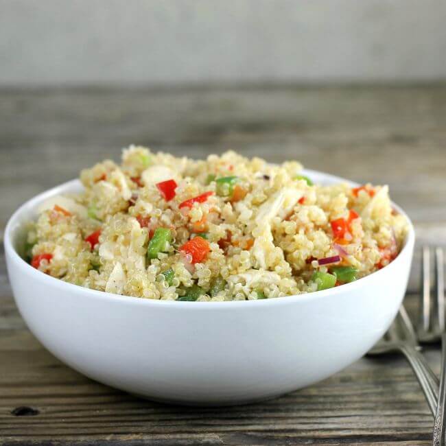 Sideview of quinoa salad in a white bowl.