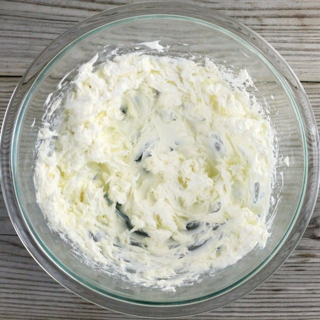 Cream cheese that has been beaten in a bowl.
