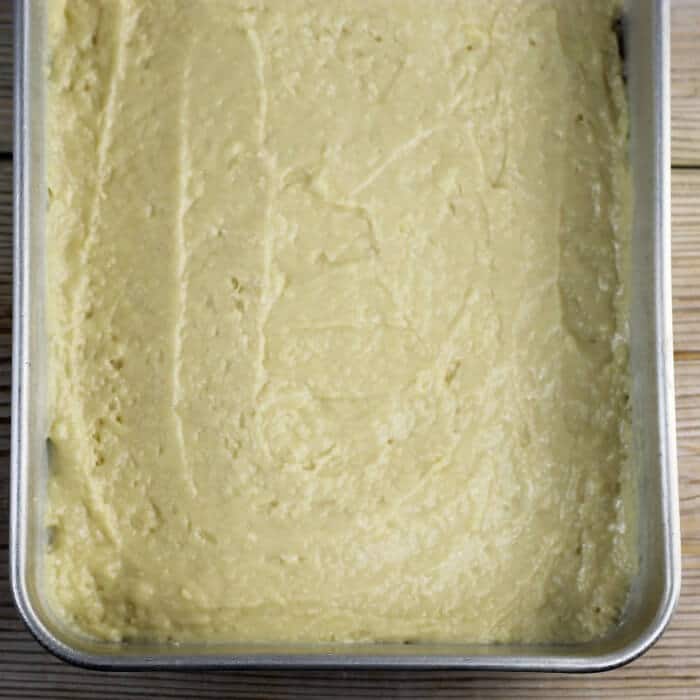 The batter is spread into a baking pan. 