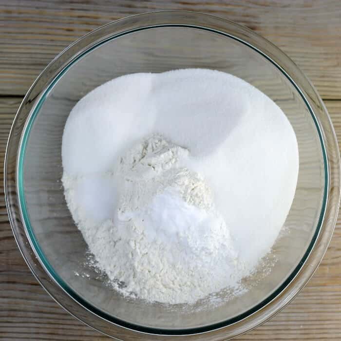 Looking down at a bowl with flour, sugar, baking powder, soda, and salt.