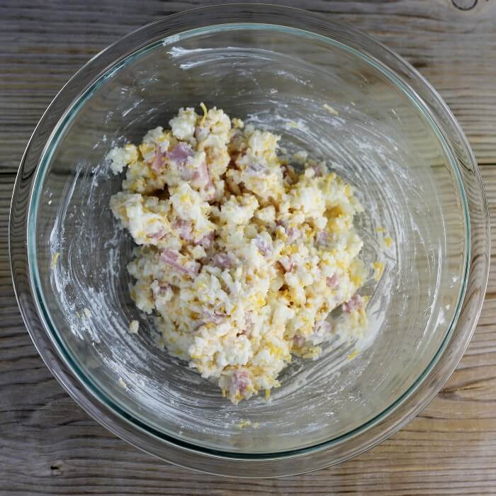 Mashed potato and ham mixture in a mixing bowl.