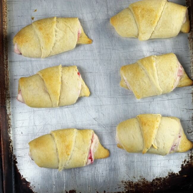 Baked crescent rolls on a baking sheet. 