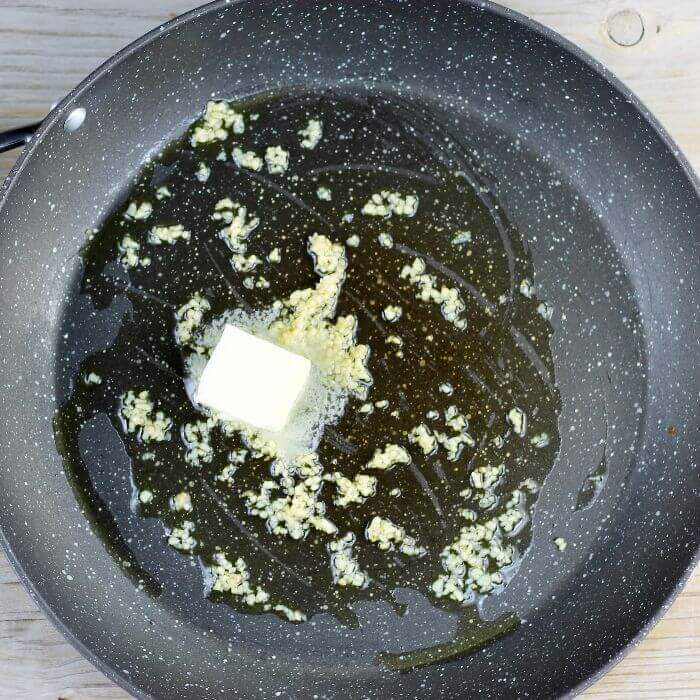The butter is added to the skillet with the olive oils and garlic.