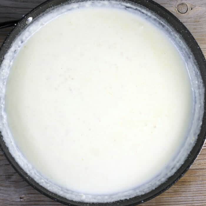The cream and milk are added to the skillet.