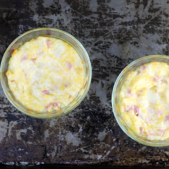 Overlooking a couple of bowls with baked mashed potatoes.