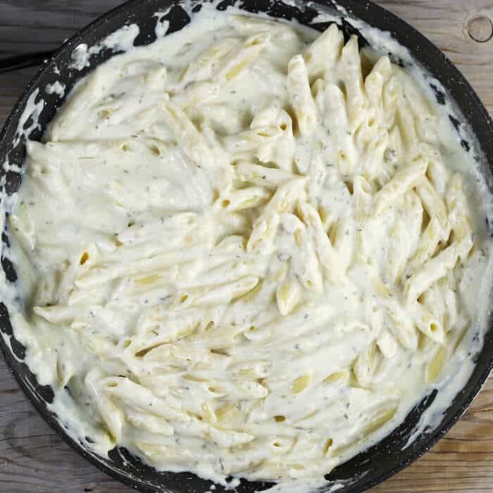 Overlooking a skillet with creamy pasta. 