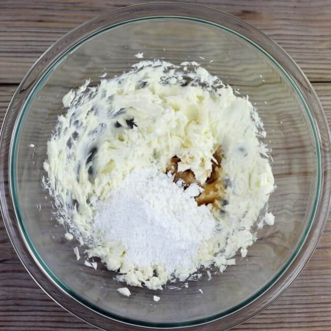 Powdered sugar and vanilla are added to the cream cheese.