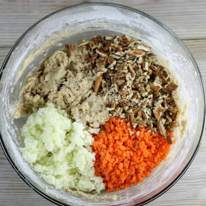 Nuts, carrots, and apples are added to the cookie dough.