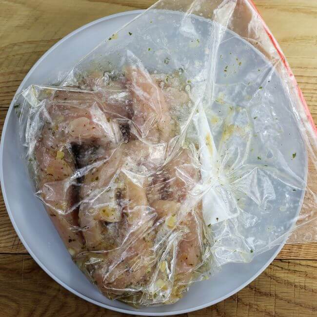 Chicken in a ziplock bag with marinade.