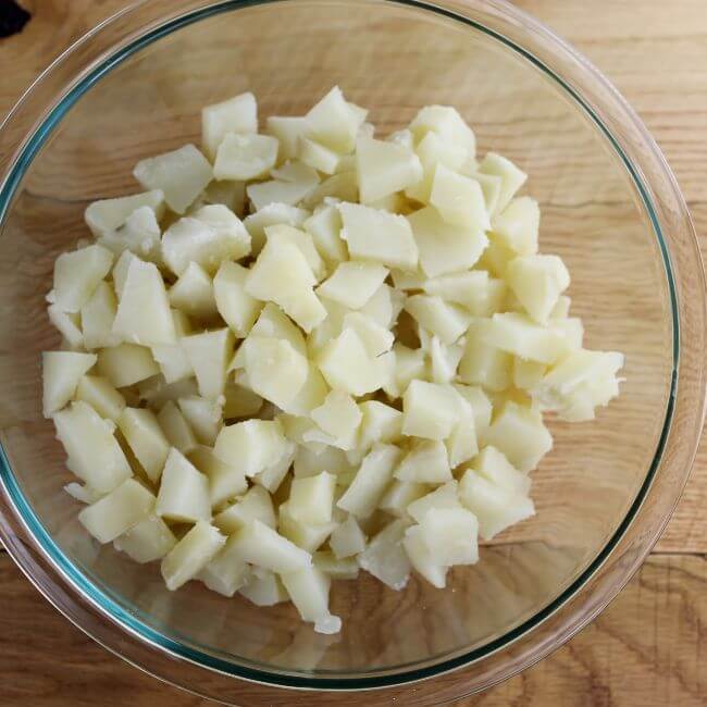Looking down at a bowl of cubed potatoes.