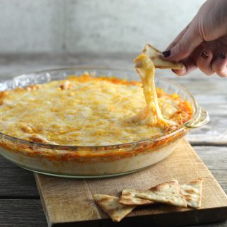 Layered Buffalo chicken dip can be eaten with crackers, chips, veggies...