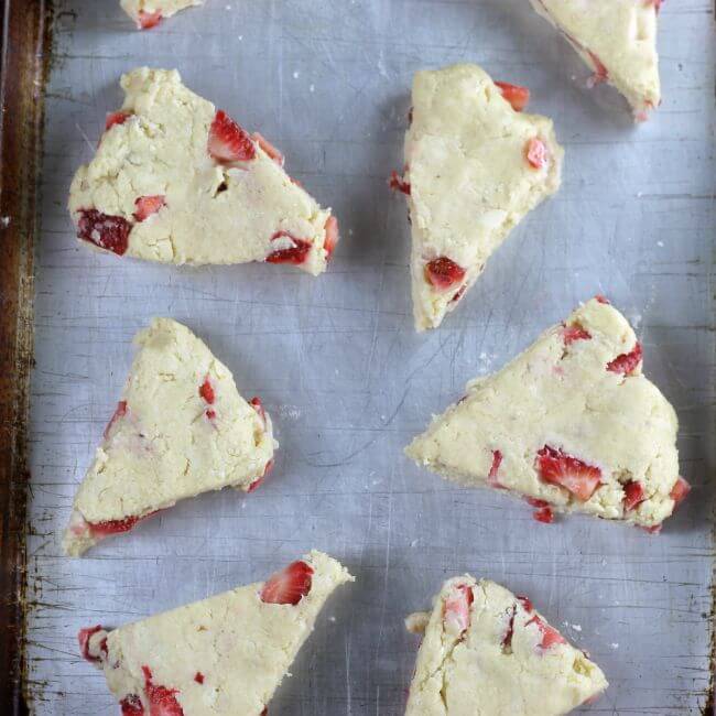 Unbaked scones on a baking sheet.