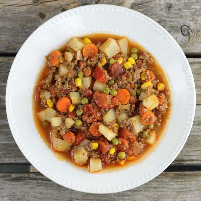 Easy hamburger stew in a white bowl.