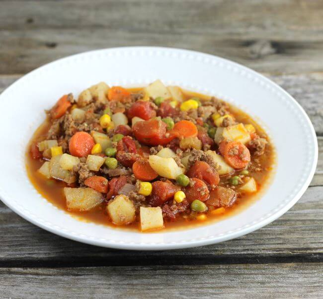 Easy hamburger stew in a white bowl.