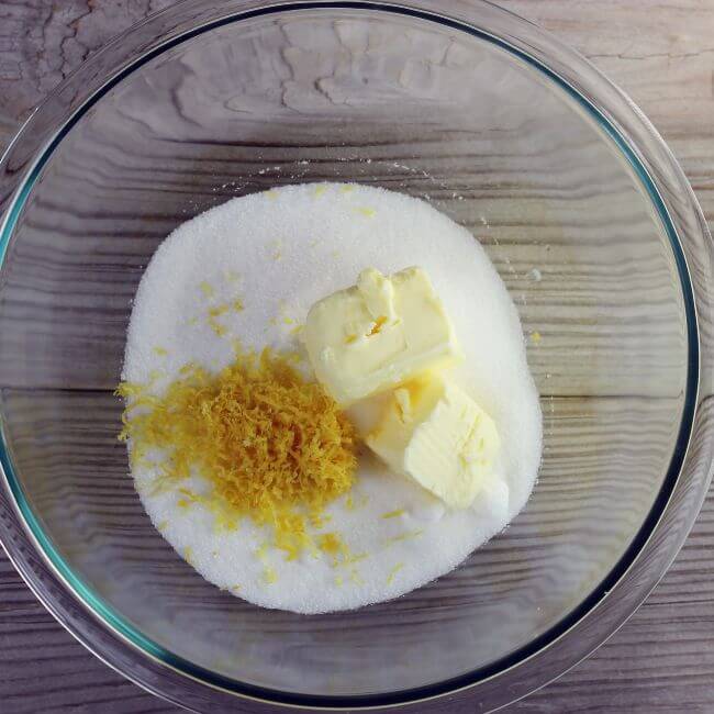 Lemon zest, butter, and sugar in a glass bowl.