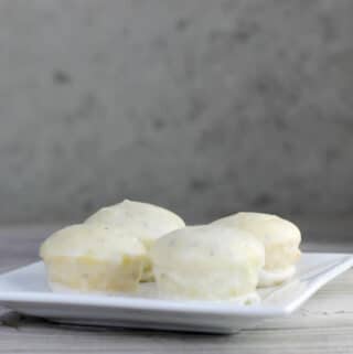 A side view of a white plate with mini cakes on it.