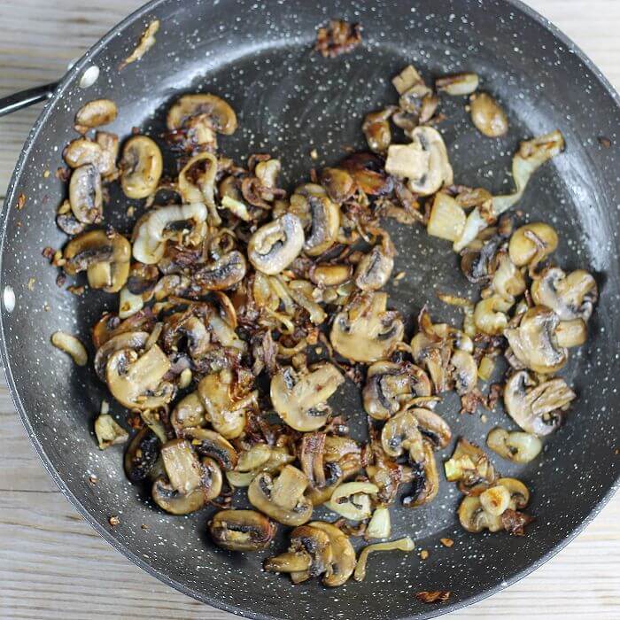 Caramelized mushrooms and onions in a skillet. 