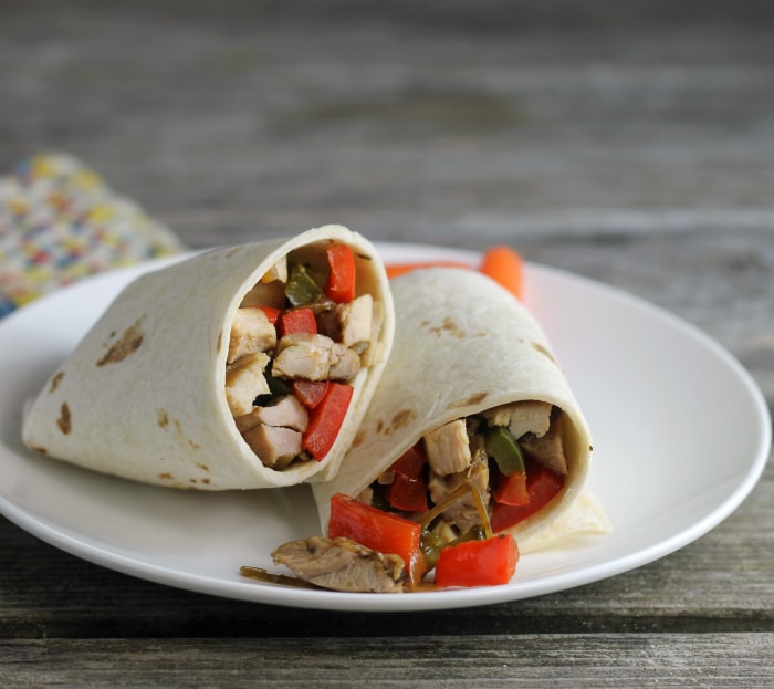 Soft Italian chicken wraps filled with chicken, peppers, and onions