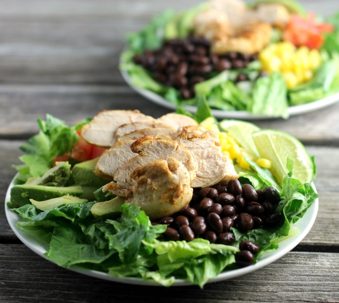 Southwest chicken salad topped with corn, tomatoes, black beans, avocados, and ranch dressing