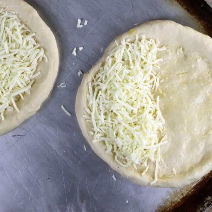Olive oil and mozzarella are added to the crust. 