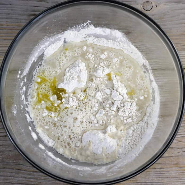 Warm water and olive oil are added to the flour mixture. 