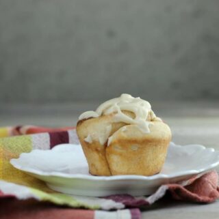 Looking at a side view of a cinnamon roll muffin.