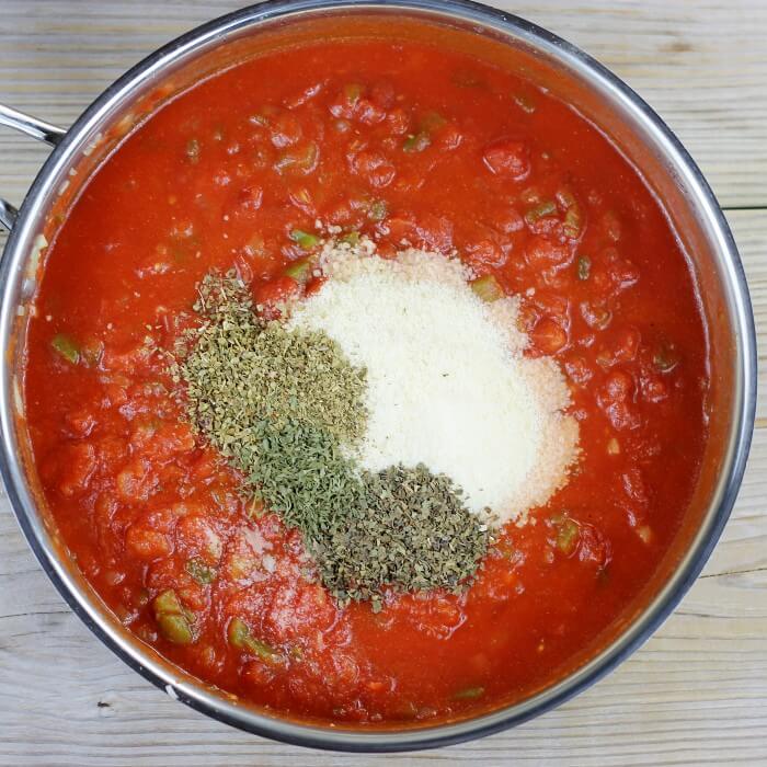 Parmesan cheese and seasonings are added to the tomato sauce. 