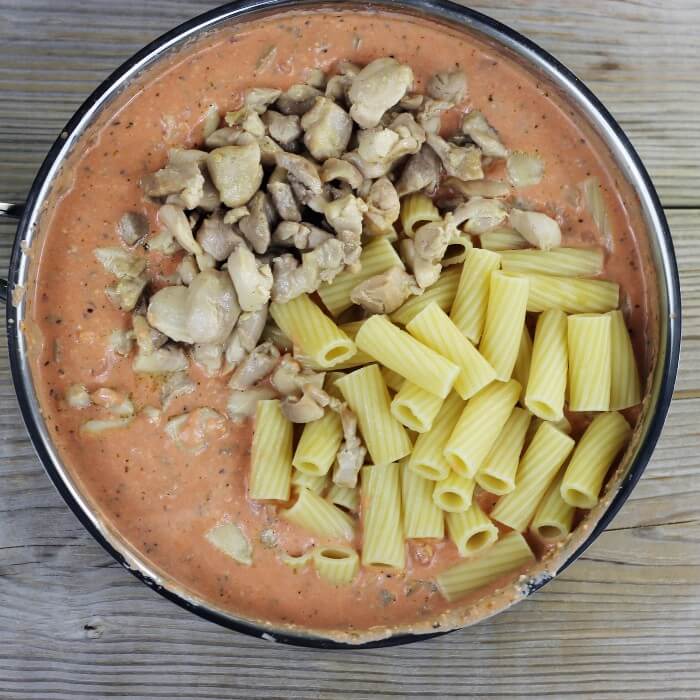 Chicken and pasta are then added to the skillet. 