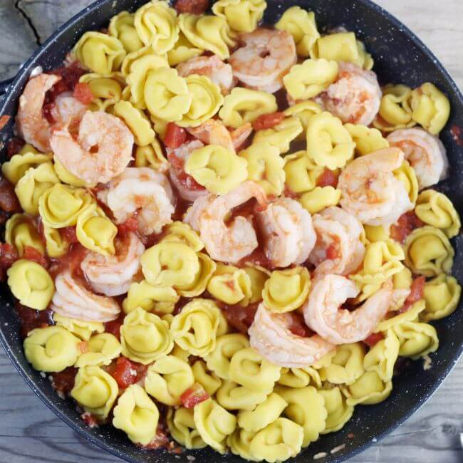 Tortelline is added to the skillet.