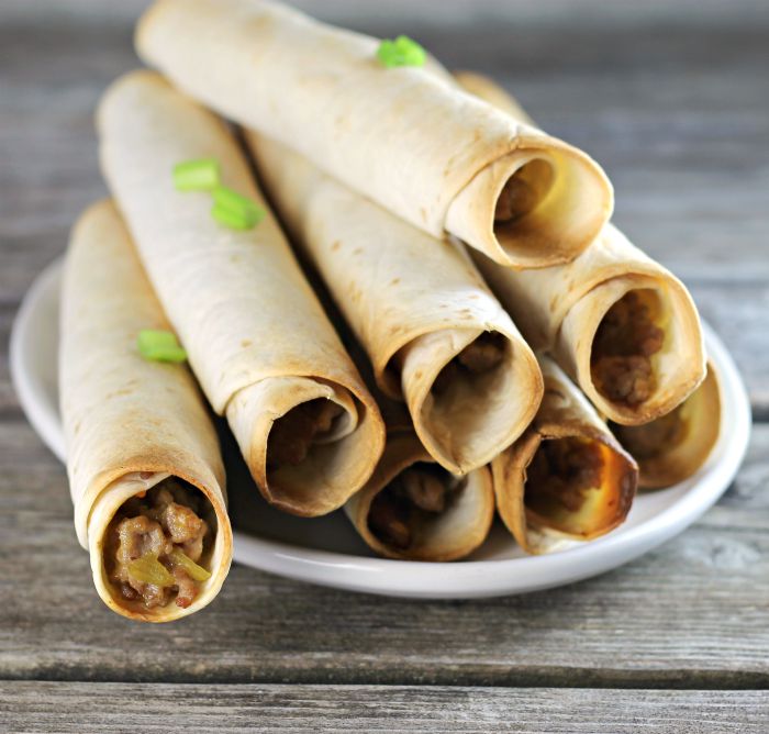 Baked pork taquitos are filled with ground pork and cheese served with salsa, sour cream, or your favorite dip.