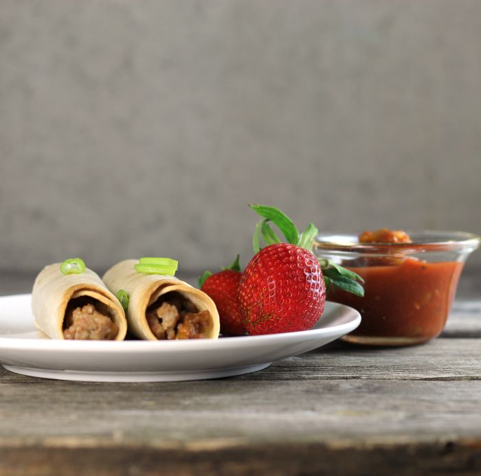 Baked pork taquitos are filled with ground pork and cheese served with salsa, sour cream, or your favorite dip.