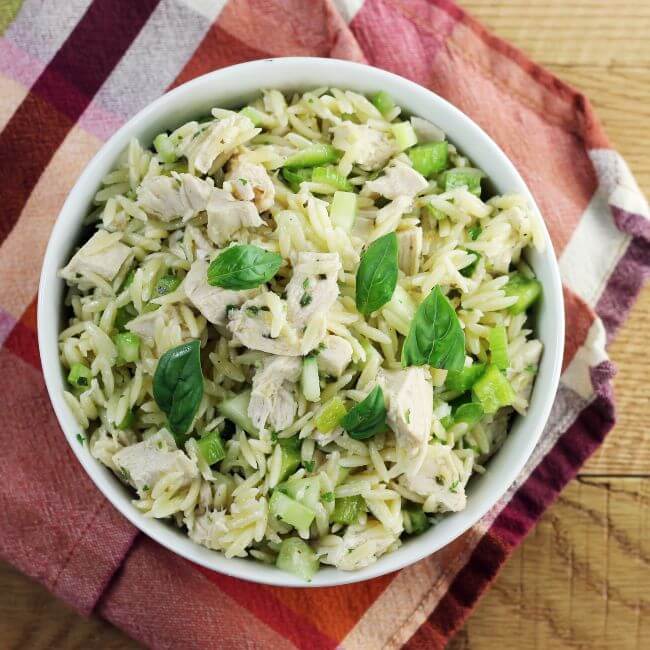 Looking down at a bowl of chicken orzo salad.